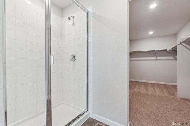 bathroom featuring a shower with shower door