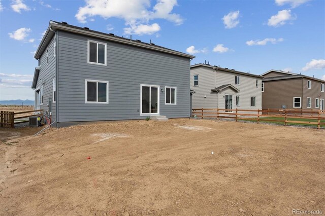 back of house featuring central AC