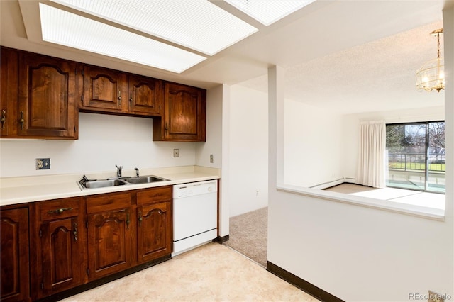 kitchen with dishwasher, sink, a notable chandelier, light colored carpet, and decorative light fixtures