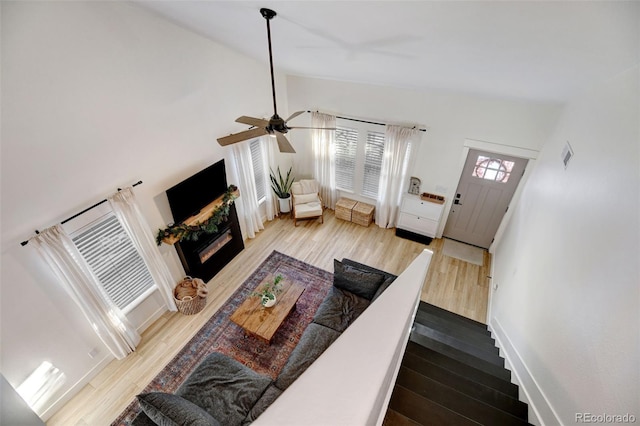 living room featuring high vaulted ceiling, ceiling fan, and light hardwood / wood-style floors