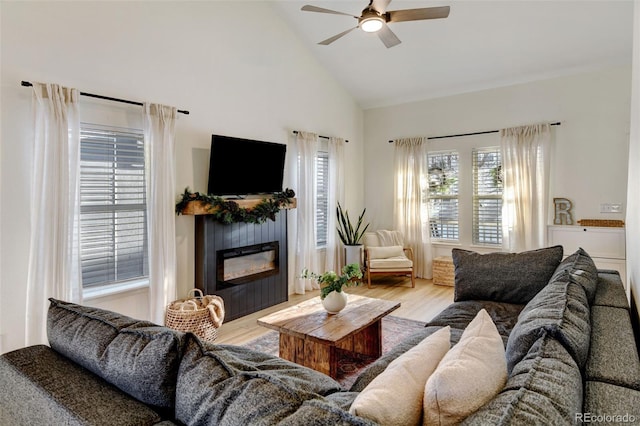 living room featuring ceiling fan, light hardwood / wood-style flooring, and high vaulted ceiling