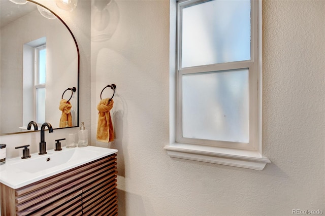 bathroom with a healthy amount of sunlight and vanity