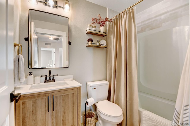 full bathroom with toilet, vanity, and shower / bath combo with shower curtain