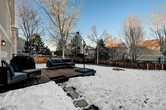 yard covered in snow featuring outdoor lounge area and a wooden deck