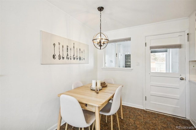 dining space with ornamental molding and a notable chandelier