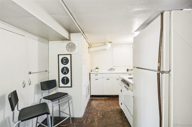 kitchen with white appliances and white cabinets