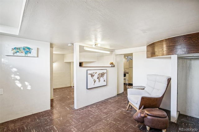 living area featuring a textured ceiling