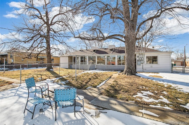 snow covered property with a sunroom