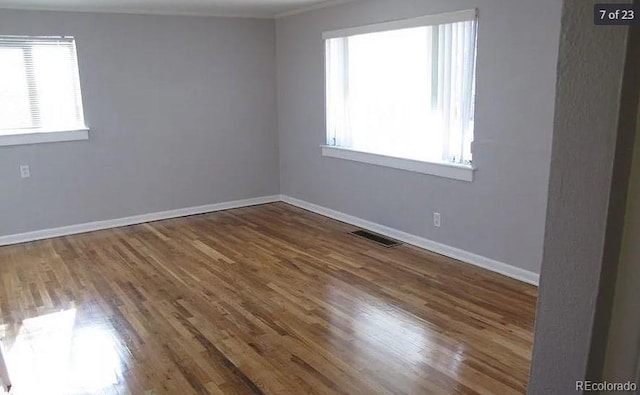 unfurnished room with dark wood-type flooring