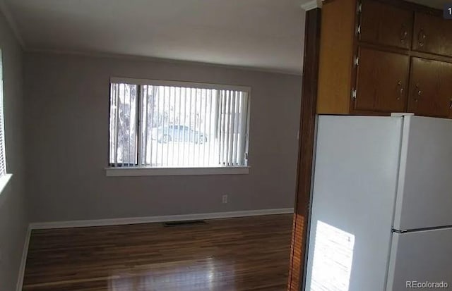 kitchen featuring white refrigerator and dark hardwood / wood-style flooring