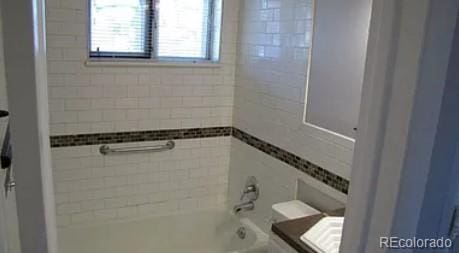 full bathroom featuring vanity, toilet, and tiled shower / bath combo