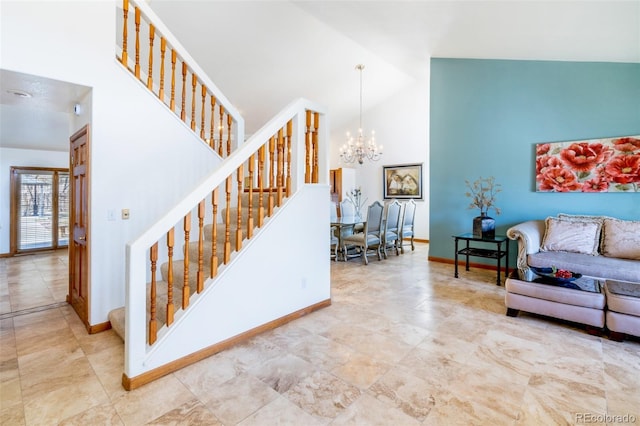 staircase featuring baseboards, high vaulted ceiling, and an inviting chandelier