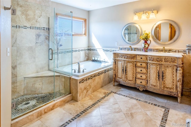 bathroom with a stall shower, a garden tub, and a sink
