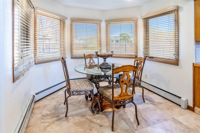 dining area featuring a baseboard heating unit and baseboards