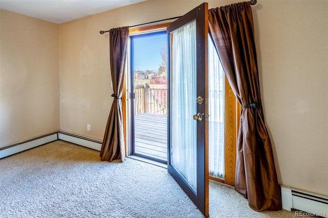 empty room featuring baseboard heating and carpet floors