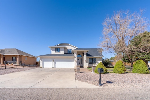 view of front of house featuring concrete driveway, stucco siding, fence, and an attached garage