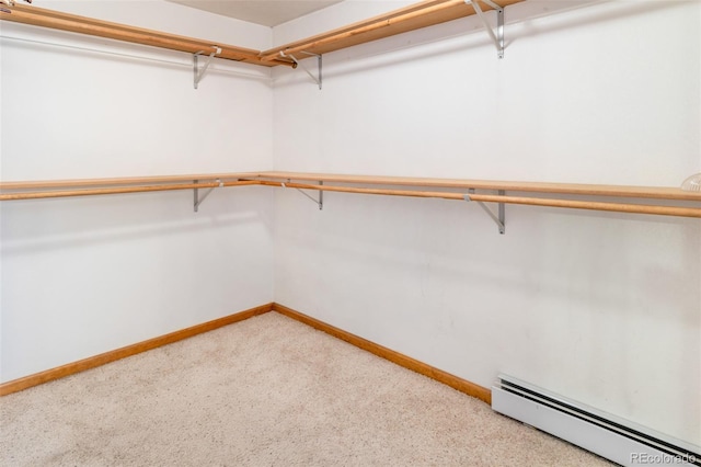 spacious closet featuring carpet flooring and a baseboard heating unit