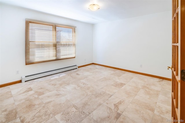 spare room with baseboard heating and baseboards