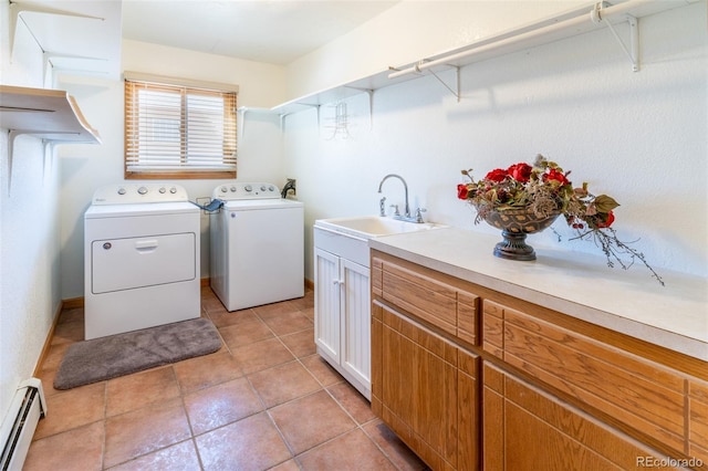 laundry area with light tile patterned flooring, cabinet space, washer and dryer, a baseboard radiator, and a sink