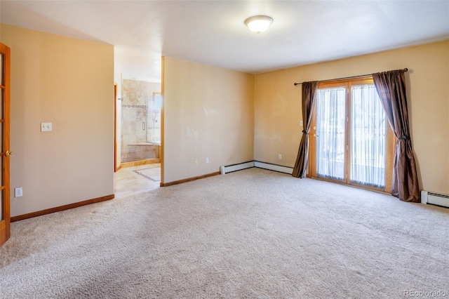carpeted empty room with baseboard heating and baseboards