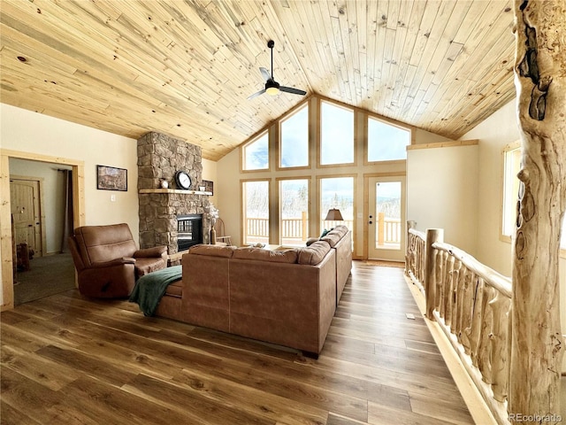 living area featuring wood ceiling, a fireplace, and wood finished floors