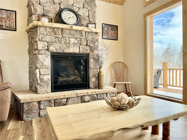 sitting room with a fireplace and wood finished floors