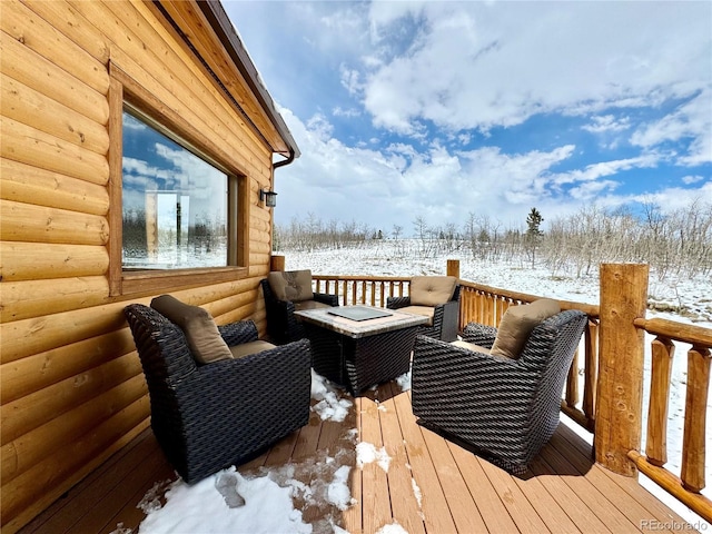 snow covered deck with an outdoor living space