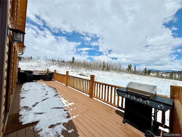 snow covered deck with a grill