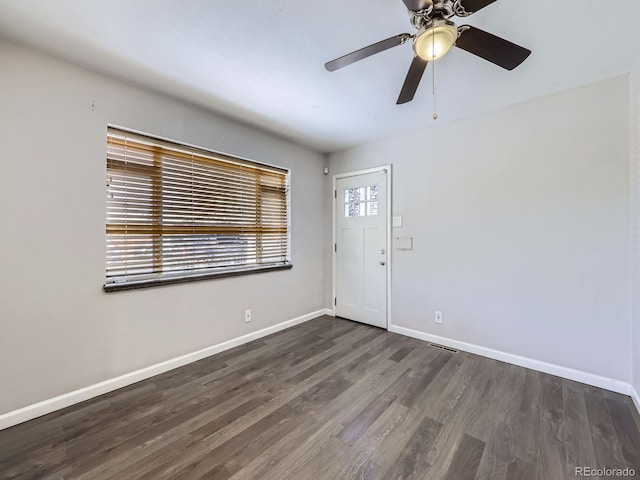 unfurnished room with ceiling fan and dark hardwood / wood-style flooring