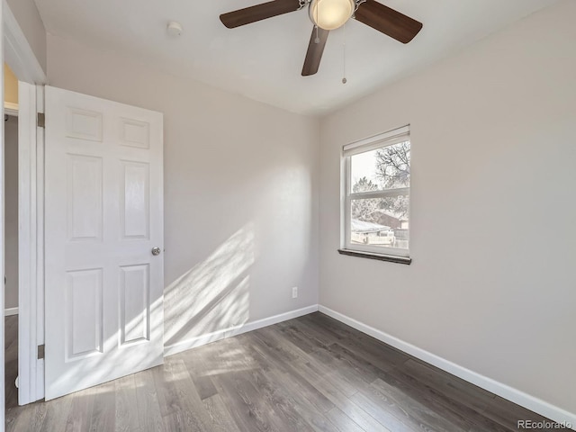 unfurnished room with dark wood-type flooring