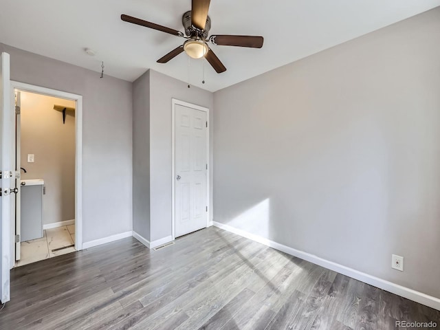 unfurnished bedroom featuring hardwood / wood-style floors and ceiling fan