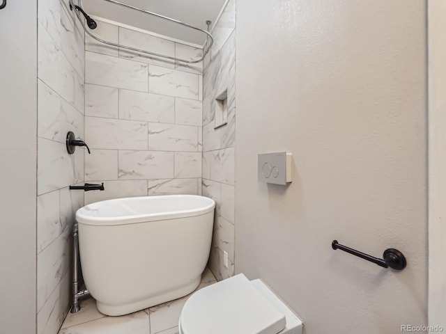 bathroom with a tub to relax in, toilet, and tile walls