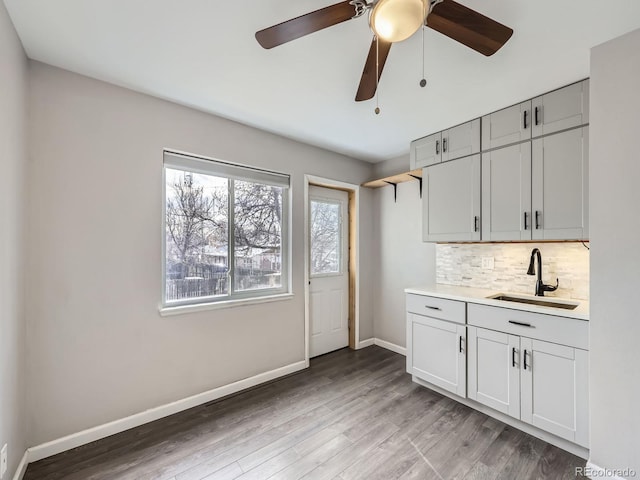 kitchen with sink, decorative backsplash, and light hardwood / wood-style floors