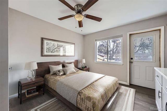 bedroom with ceiling fan and dark hardwood / wood-style floors