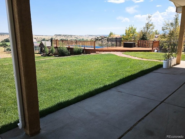 view of yard featuring a deck with mountain view