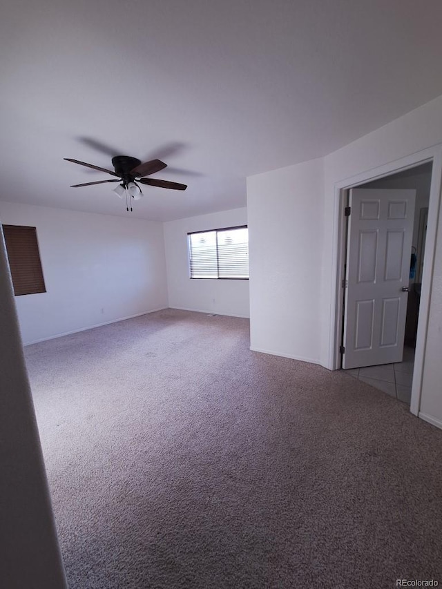 empty room with ceiling fan and light colored carpet