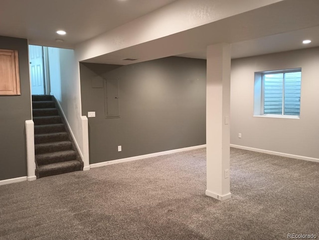 basement featuring electric panel and carpet floors