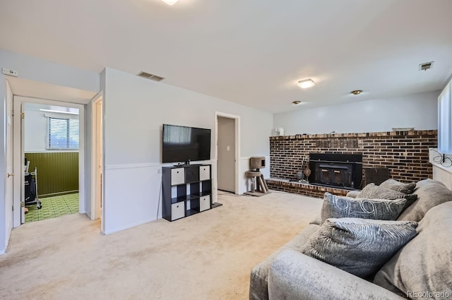 living room featuring visible vents, carpet flooring, and a fireplace