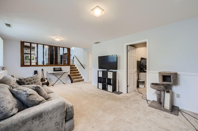 carpeted living room featuring stairs and visible vents