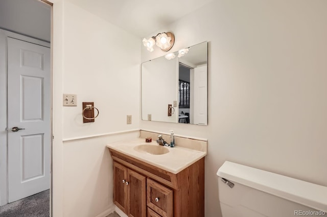 bathroom featuring toilet and vanity