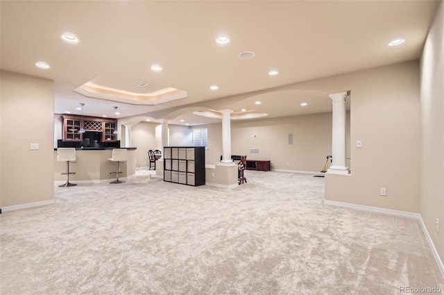 interior space with light colored carpet, recessed lighting, bar, and baseboards