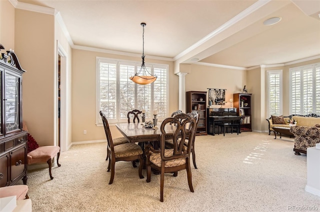 dining space featuring crown molding, baseboards, a wealth of natural light, and light colored carpet