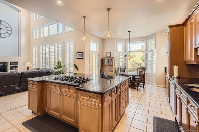 kitchen with stainless steel appliances, plenty of natural light, and light tile patterned floors