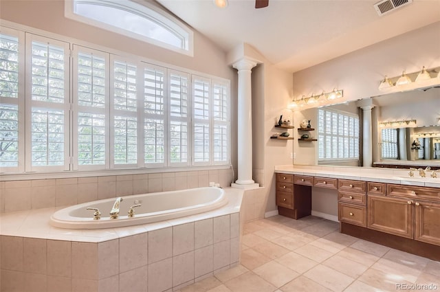 bathroom featuring plenty of natural light, ornate columns, a bath, and visible vents