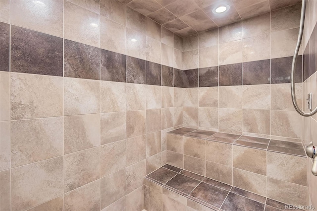 room details with recessed lighting and tiled shower