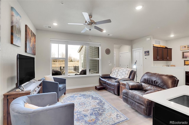 living room with recessed lighting, visible vents, and light wood-style flooring