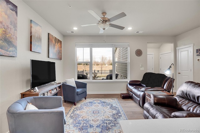 living area featuring recessed lighting, light wood-type flooring, baseboards, and visible vents