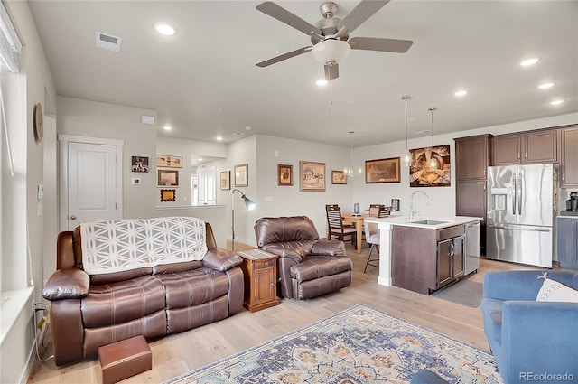 living area featuring a ceiling fan, visible vents, recessed lighting, and light wood-type flooring