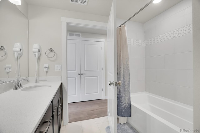 full bathroom featuring tile patterned floors, visible vents, vanity, and shower / bath combo