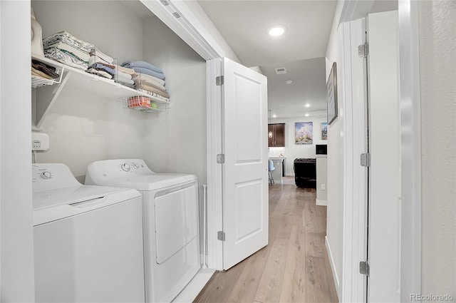 washroom featuring light wood finished floors, visible vents, laundry area, recessed lighting, and separate washer and dryer